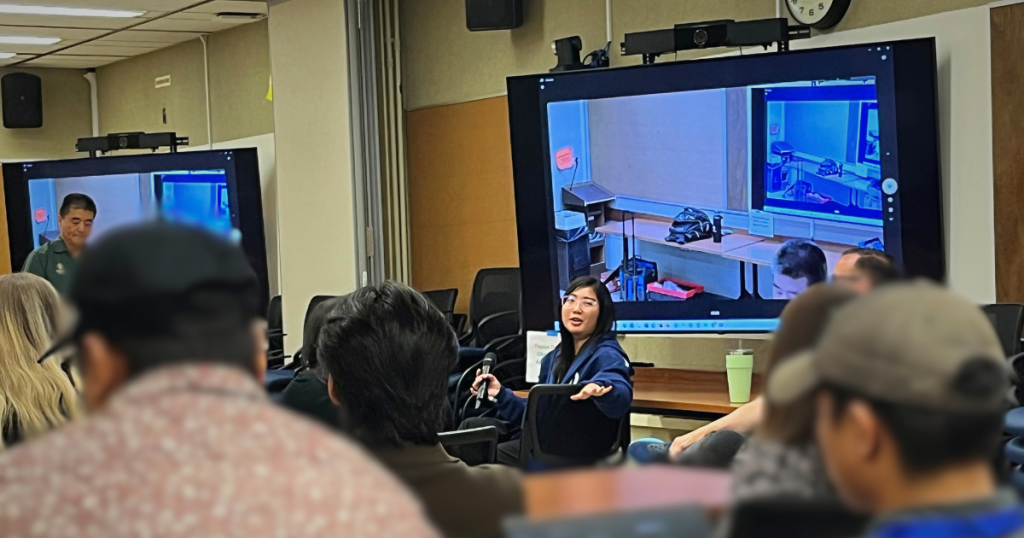 A woman giving a presentation to a group.