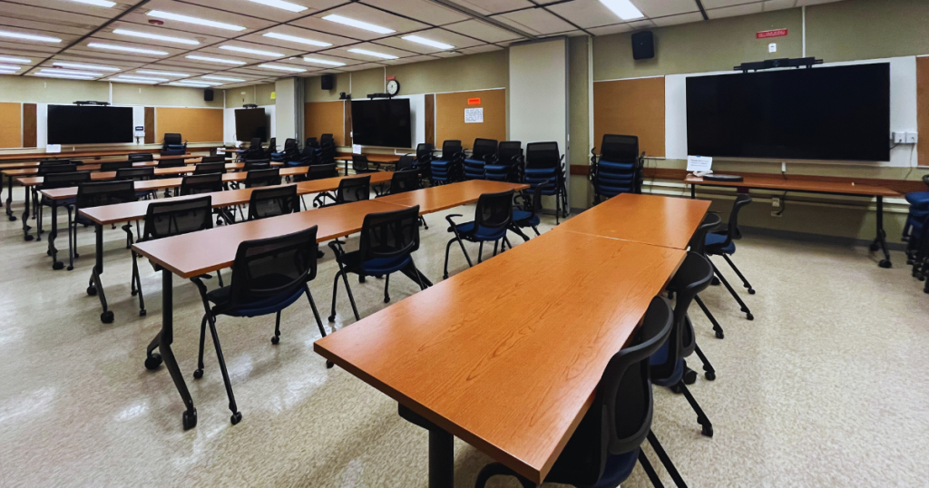 Large conference room with brand new tables, chairs and monitors