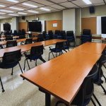 Large conference room with brand new tables, chairs and monitors