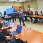 Large conference room with various State of Hawaii employees meeting to discuss the organizational impacts of the EFS Project on their respective departments.