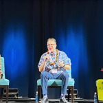 Three executive panel speakers seated on a stage during the 2024 Hawaii Digital Government Summit.