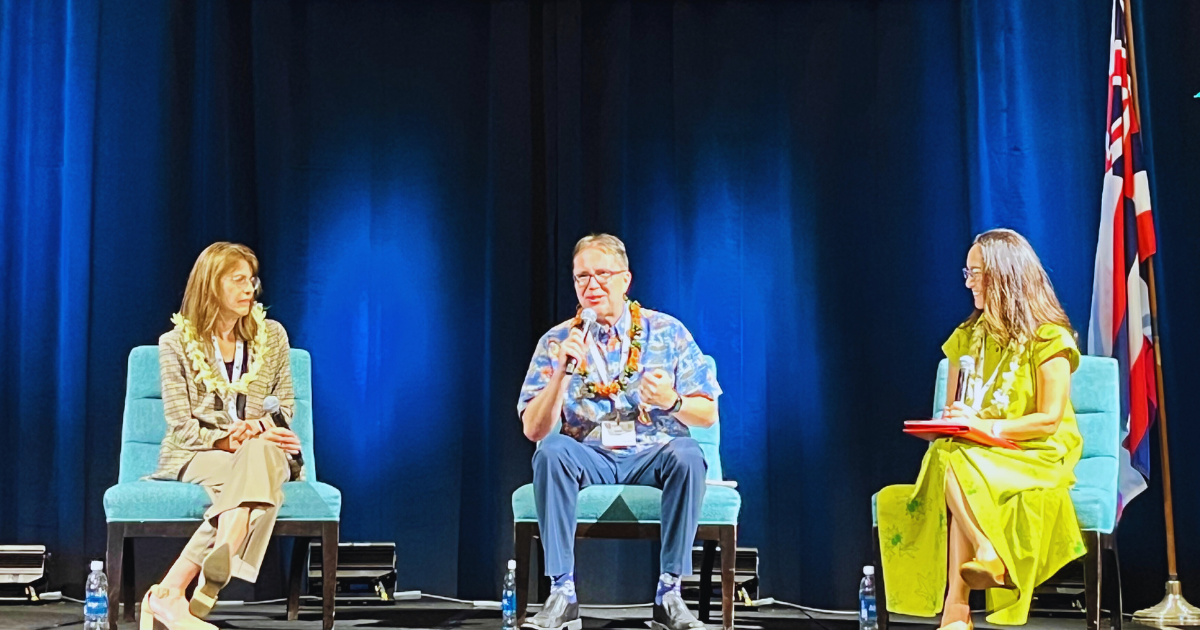 Three executive panel speakers seated on a stage during the 2024 Hawaii Digital Government Summit.