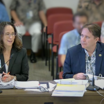 Executive sponsors Keith Regan, DAGS Comptroller, and Christine Sakuda, State CIO and ETS Administrator, are seated at a table as they meet with members of the the Senate Committee on Ways and Means and the House Committee on Finance.