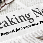 Image of a pair of glasses and a pen on top of a news paper with the headline: "Breaking News: EFS Request for Proposals Published!"