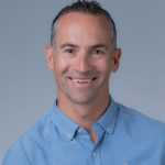 Corporate headshot of an adult male wearing a light blue collared shirt. Headshot of Yovo Stefanov, Business Transformation Office Project Director, DAGS.