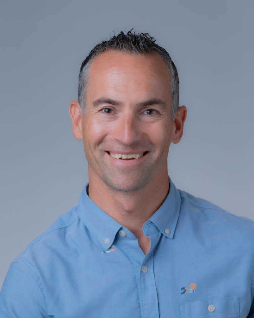 Corporate headshot of an adult male wearing a light blue collared shirt. Headshot of Yovo Stefanov, Business Transformation Office Project Director, DAGS.