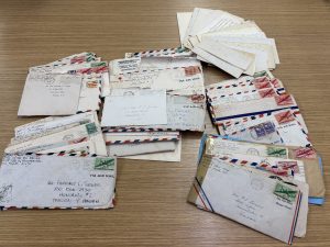 Old letters from 1944 and 1945 spread out on a table. 