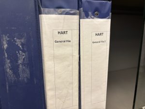 Two 3-ring binders with the words HART on them